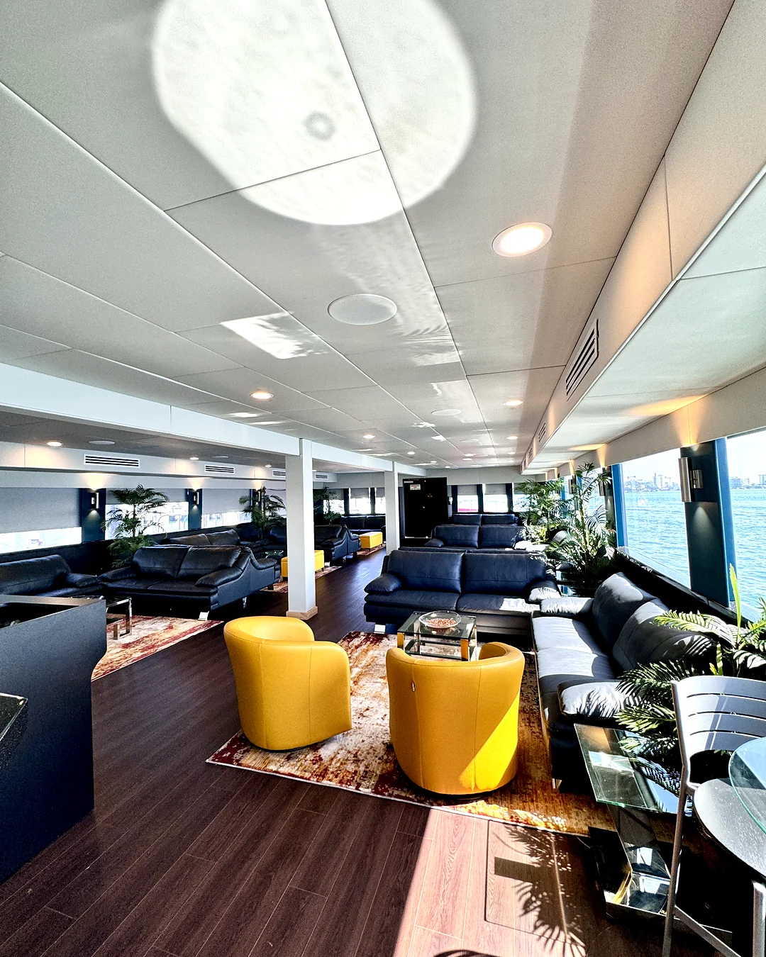 Salon lounge with yellow chairs aboard Opus Yacht Miami