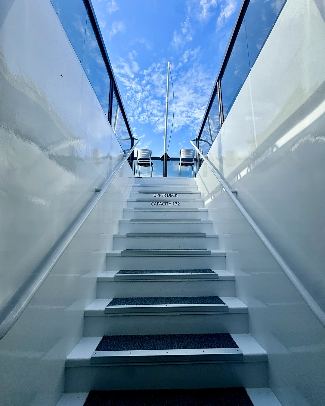 White staircase aboard Opus Yacht Miami