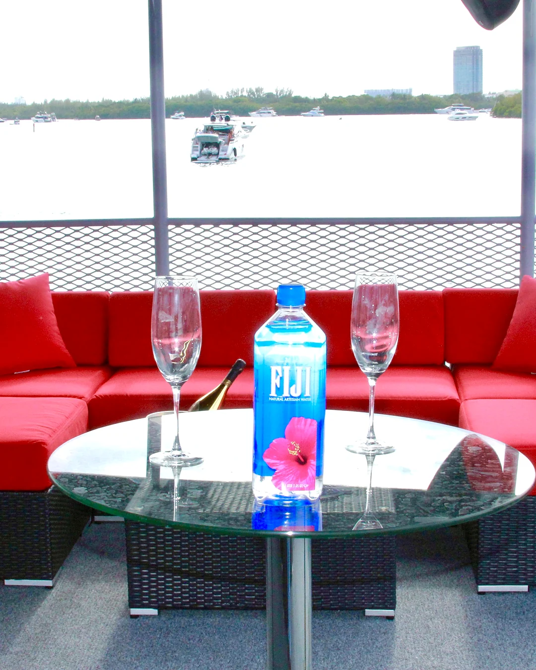 Red lounge bottle-service setup aboard Opus Yacht Miami